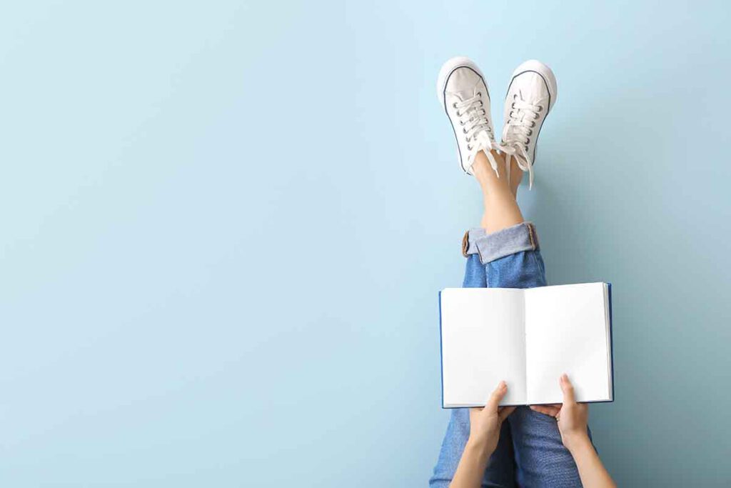 Woman with book on color background